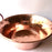 Mexico 1492: A hammered copper saucepan (or better known as cazo in Mexico), handmade in Santa Clara del Cobre, by one of the oldest, most respected coppersmith workshops of don Viduel. The copper hammering process is lengthy and arduous, but the shaping is done through a series of soft hammer blows that create the recognizable indentations on the surface. 