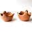 Mexico 1492: Graceful salsa bowl shaped as a bird with wings, made from red clay with a yellowish tone and marked with random flame spots, adding character. Best for serving salsa, appetizers, or salt and spices. Lead free, unglazed. Thanks to the artisanal nature of this handmade product, no two pieces are the same. 