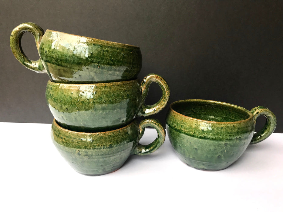 Mexico 1492: A wide, green glazed clay cup, with beautiful texture on the outside, and a symbolic swirl on the inside. Ideal for the morning cup of rich, foamy Oaxacan coffee, and a piece of sweet bread served with it.   Lead-free, handmade and glazed by the amazing artisans in Oaxaca, Mexico. 