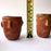 Mexico 1492: Stunning shot glasses with Zapotec profile-shaped ornaments, made from red clay and marked with random flame spots, adding character. Excellent for serving tequila or mezcal. Lead free, unglazed. Thanks to the handmade nature and the flame marks, no two pieces are the same, or even of the same height, which adds a lot of charm and informality. 