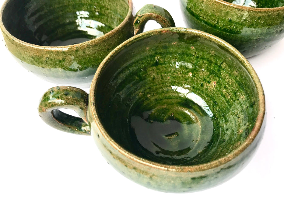 Mexico 1492: A wide, green glazed clay cup, with beautiful texture on the outside, and a symbolic swirl on the inside. Ideal for the morning cup of rich, foamy Oaxacan coffee, and a piece of sweet bread served with it.   Lead-free, handmade and glazed by the amazing artisans in Oaxaca, Mexico. 