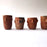 Mexico 1492: Stunning shot glasses with Zapotec profile-shaped ornaments, made from red clay and marked with random flame spots, adding character. Excellent for serving tequila or mezcal. Lead free, unglazed. Thanks to the handmade nature and the flame marks, no two pieces are the same, or even of the same height, which adds a lot of charm and informality. 