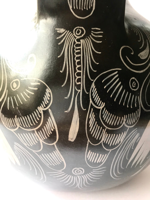 Mexico 1492: A jaguar shaped pitcher (called “cántaro” in Mexico), hand made, hand painted, carefully burnished using the river stones and finished in a fire. The jaguar motif is frequently found in Mexican mythology and ethnic arts, but this one is especially carefully created, and thoughtfully adorned with natural elements like flowers, birds, rain and wings. Used for storing liquids, like water or wine. 