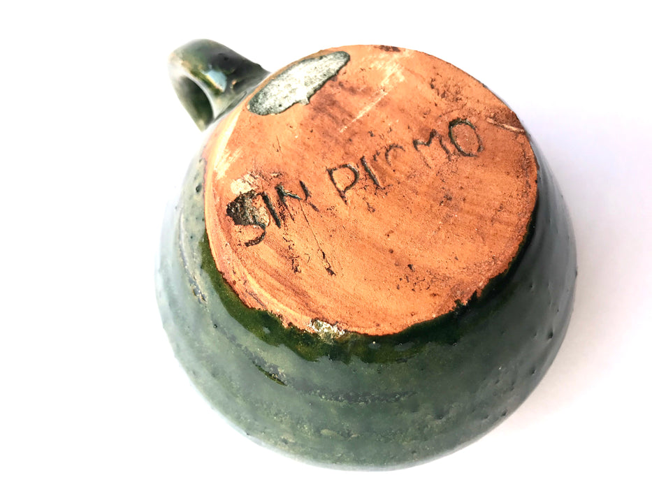 Mexico 1492: A wide, green glazed clay cup, with beautiful texture on the outside, and a symbolic swirl on the inside. Ideal for the morning cup of rich, foamy Oaxacan coffee, and a piece of sweet bread served with it.   Lead-free, handmade and glazed by the amazing artisans in Oaxaca, Mexico. 