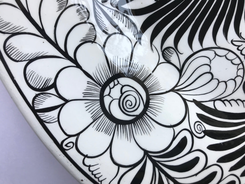 Mexico 1492: The talented young artisan Isabel from Guerrero created this amazing, large, black and white serving plate, hand painted with motifs of birds and greenery, and glazed. An eye-catcher, and a piece that beings the traditional folk art to the modern era in a seamless way.