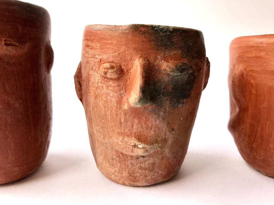 Mexico 1492: Stunning shot glasses with Zapotec profile-shaped ornaments, made from red clay and marked with random flame spots, adding character. Excellent for serving tequila or mezcal. Lead free, unglazed. Thanks to the handmade nature and the flame marks, no two pieces are the same, or even of the same height, which adds a lot of charm and informality. 