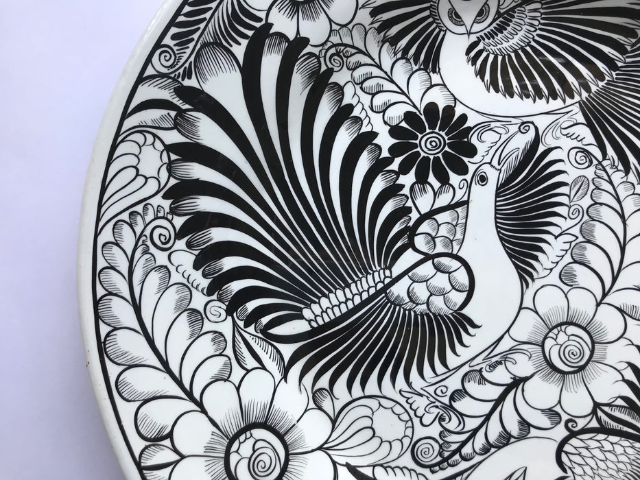 Mexico 1492: The talented young artisan Isabel from Guerrero created this amazing, large, black and white serving plate, hand painted with motifs of birds and greenery, and glazed. An eye-catcher, and a piece that beings the traditional folk art to the modern era in a seamless way.