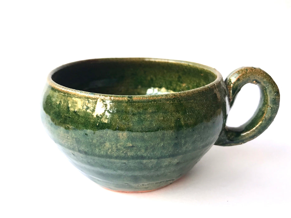 Mexico 1492: A wide, green glazed clay cup, with beautiful texture on the outside, and a symbolic swirl on the inside. Ideal for the morning cup of rich, foamy Oaxacan coffee, and a piece of sweet bread served with it.   Lead-free, handmade and glazed by the amazing artisans in Oaxaca, Mexico. 