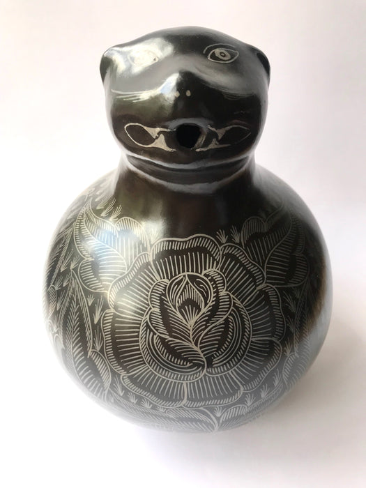 Mexico 1492: A jaguar shaped pitcher (called “cántaro” in Mexico), hand made, hand painted, carefully burnished using the river stones and finished in a fire. The jaguar motif is frequently found in Mexican mythology and ethnic arts, but this one is especially carefully created, and thoughtfully adorned with natural elements like flowers, birds, rain and wings. Used for storing liquids, like water or wine. 
