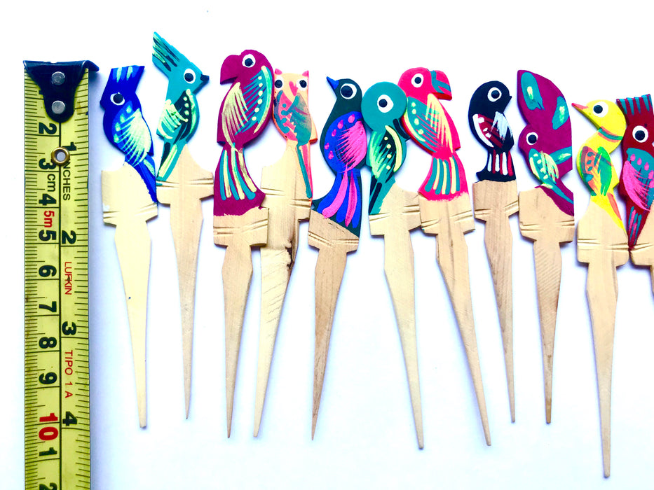 Mexico 1492: Painted Wooden Bird Shaped Picks. Ideal for serving cheese cubes, olives, or appetizers of any kind, but also the lemon slices with tequila, or the orange slices with a smooth, smoky mezcal shot. Colorful, hand-painted, with the bird pattern, this Oaxacan basic utensil, so simple in function but so rich in visual effect, enlightens your reunions like no other pick can.