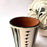 Mexico 1492: The off-white “cántaro” (pitcher), hand made out of clay, hand painted with jewels of the Michoacan nature,  and burnished to shine. Accompanied by a matching glass. Used for storing liquids, like water or wine.   “Cántaro” is a precious piece in every Mexican home, and a favorite way to store water. It is believed that water stays cool in a “cántaro” even on a hottest day.