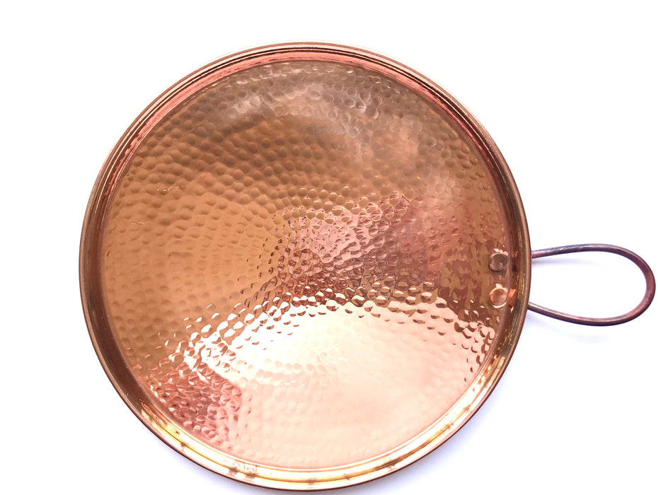 Mexico 1492: A shiny copper comal, hammered by hand. Comal (from the Nahuatl comalli) is a flat surface that, placed over fire or a stove burner, served through centuries to cook tortillas, tlacoyos, gorditas, or roast cocoa beans, and in recent centuries, coffee. 