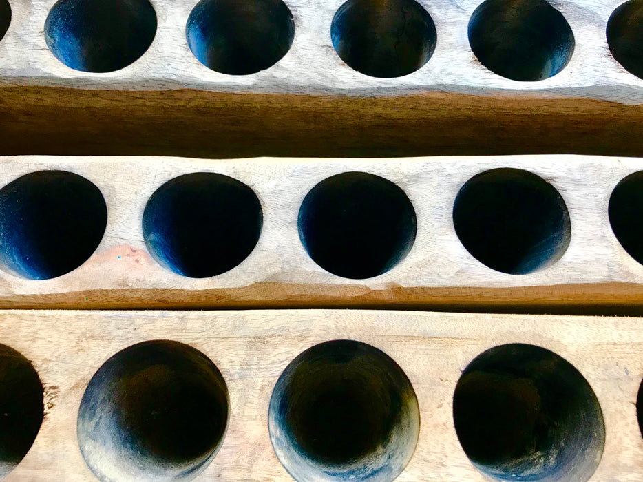 Mexico 1492: the molds like these are used as candle holders. We were lucky to find these made out of mango wood, with 12 cone-shaped holes each and a very smooth finish.   Available with or without candles and glasses. 