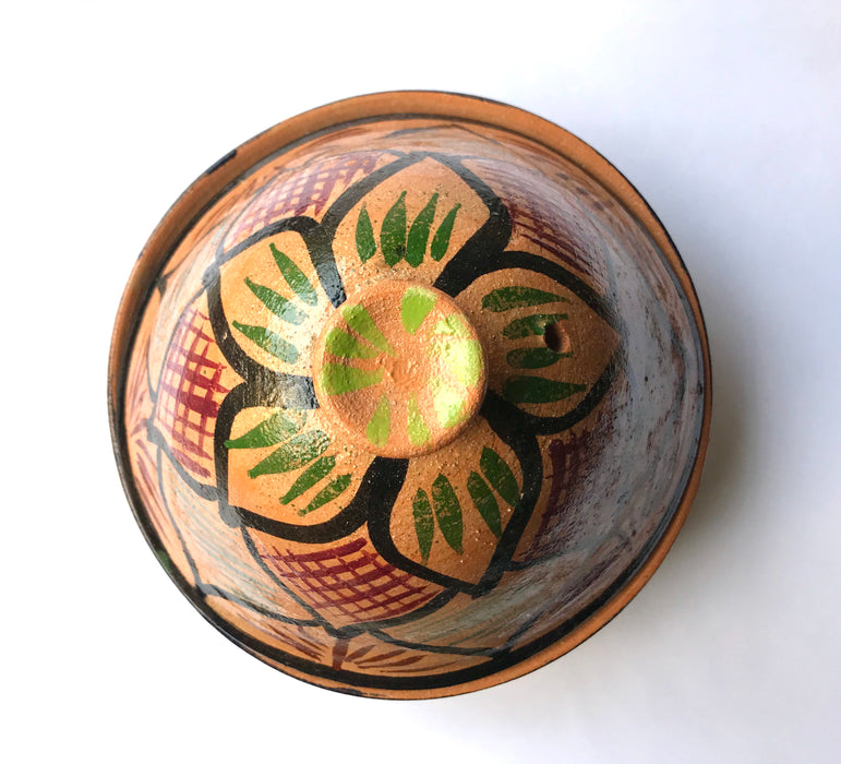 Mexico 1492: What happens when a traditional Morroccan clay dish gets transformed by warm, colorful, unstoppable Mexican creativity? Don Abel y doña Matea created a cultural fusion of Mexico and North Africa, so beautiful and imaginative. Traditional tajine, the predecessor of the modern crock pot, embellished by the talent and skill of the amazing Oaxacan artisans. Handmade, painted and lead-free glazed in Oaxaca, Mexico. Version: Black Agave.