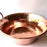 Mexico 1492: A hammered copper saucepan (or better known as cazo in Mexico), handmade in Santa Clara del Cobre, by one of the oldest, most respected coppersmith workshops of don Viduel. The copper hammering process is lengthy and arduous, but the shaping is done through a series of soft hammer blows that create the recognizable indentations on the surface. 