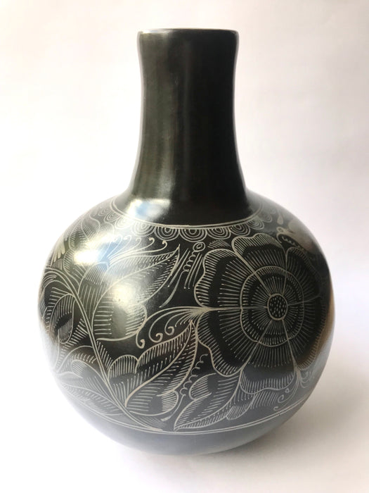 Mexico 1492: The black “cántaro” (pitcher), hand made out of clay, hand painted with birds, flowers and leaves, and burnished to shine. Accompanied by a matching glass. Used for storing liquids, like water or wine.   “Cántaro” is a precious piece in every Mexican home, and a favorite way to store water. It is believed that water stays cool in a “cántaro” even on a hottest day.