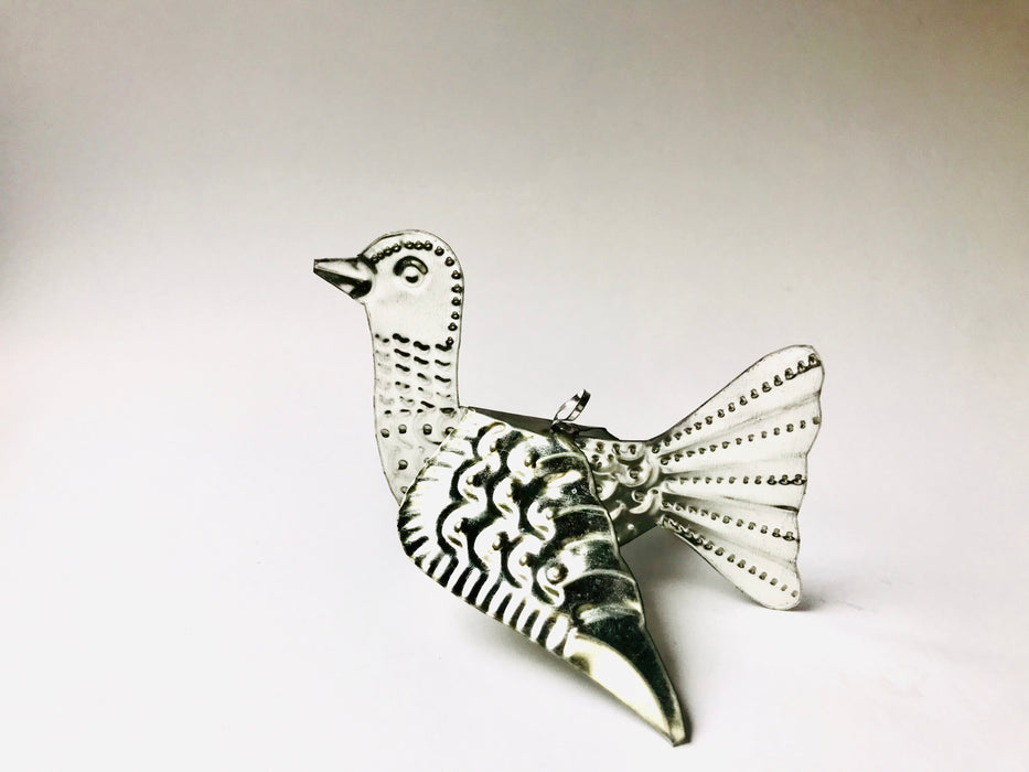 Mexico 1492 - Whimsical little bird that spreads its wings and adorns every Christmas tree, table, napkin or a fruit bowl you wish. Handmade by Oaxacan artisans, using the repujado (embossing) technique. 