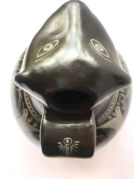 Mexico 1492: A jaguar shaped pitcher (called “cántaro” in Mexico), hand made, hand painted, carefully burnished using the river stones and finished in a fire. The jaguar motif is frequently found in Mexican mythology and ethnic arts, but this one is especially carefully created, and thoughtfully adorned with natural elements like flowers, birds, rain and wings. Used for storing liquids, like water or wine. 