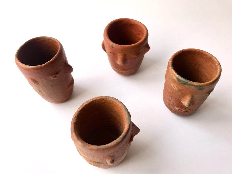 Mexico 1492: Stunning shot glasses with Zapotec profile-shaped ornaments, made from red clay and marked with random flame spots, adding character. Excellent for serving tequila or mezcal. Lead free, unglazed. Thanks to the handmade nature and the flame marks, no two pieces are the same, or even of the same height, which adds a lot of charm and informality. 