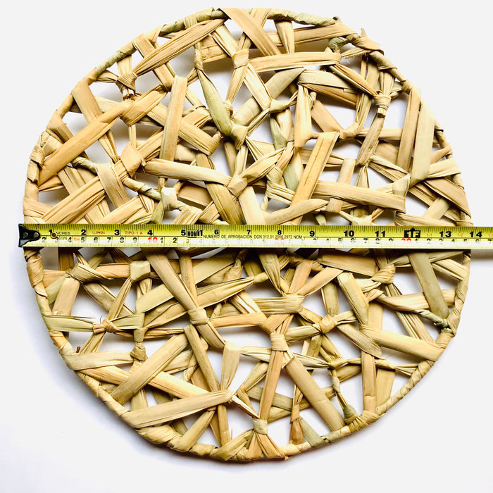 Mexico 1492 - Bulrush fiber, woven as a web on a round metalic frame. A placemat that is beautiful to look at and feels soothing under the fingertips. 