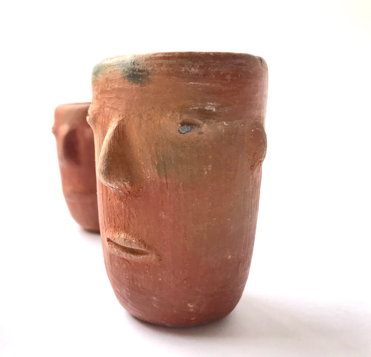 Mexico 1492: Stunning shot glasses with Zapotec profile-shaped ornaments, made from red clay and marked with random flame spots, adding character. Excellent for serving tequila or mezcal. Lead free, unglazed. Thanks to the handmade nature and the flame marks, no two pieces are the same, or even of the same height, which adds a lot of charm and informality. 