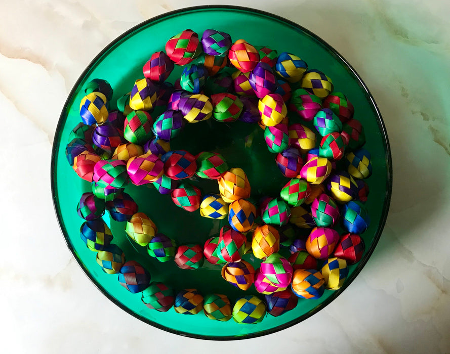 Mexico 1492: Traditional colorful Mexican Christmas decoration, a garland hand made of palm leaves in Guerrero. It can adorn a Christmas tree, or be piled up on a plate or in a fruit bowl to add a pop of color on a shelf or a table. 3.4m (11ft) long. 