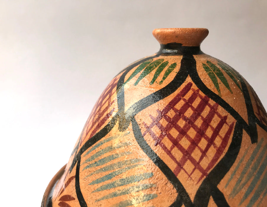 Mexico 1492: What happens when a traditional Morroccan clay dish gets transformed by warm, colorful, unstoppable Mexican creativity? Don Abel y doña Matea created a cultural fusion of Mexico and North Africa, so beautiful and imaginative. Traditional tajine, the predecessor of the modern crock pot, embellished by the talent and skill of the amazing Oaxacan artisans. Handmade, painted and lead-free glazed in Oaxaca, Mexico. Version: Black Agave.