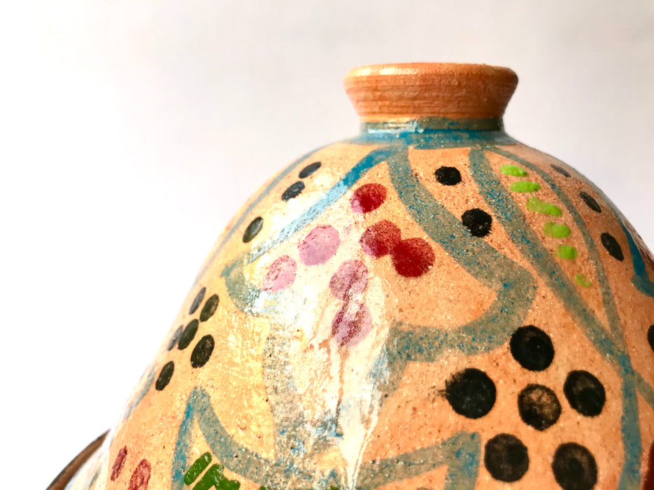 Mexico 1492: What happens when a traditional Morroccan clay dish gets transformed by warm, colorful, unstoppable Mexican creativity? Don Abel y doña Matea created a cultural fusion of Mexico and North Africa, so beautiful and imaginative. Traditional tajine, the predecessor of the modern crock pot, embellished by the talent and skill of the amazing Oaxacan artisans.  Handmade, painted and lead-free glazed in Oaxaca, Mexico.  Version: Grapevine.