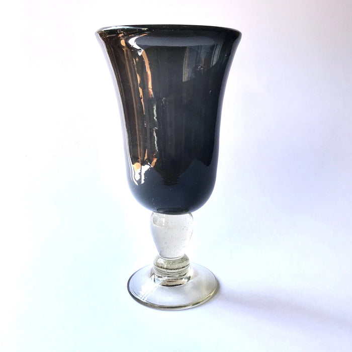 Mexico 1492: Shaped like a colored bell, with a transparent stem and foot, and hundreds of air bubbles reflecting the light, these classic wine glasses are a centerpiece and a conversation starter. Hand made with care, reflecting decades of traditional Mexican glass factories.  Available in Amethyst Purple, Turquoise, Fire Red, Cobalt Blue, Emerald Green, Lime Green and Smoke. 