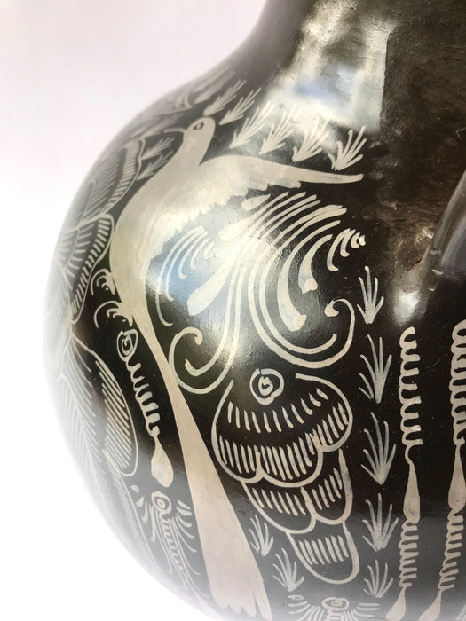 Mexico 1492: A jaguar shaped pitcher (called “cántaro” in Mexico), hand made, hand painted, carefully burnished using the river stones and finished in a fire. The jaguar motif is frequently found in Mexican mitology and ethnic arts, but this one is especially carefully created, and thoughtfully adorned with natural elements like flowers, birds, rain and wings. Used for storing liquids, like water or wine. 