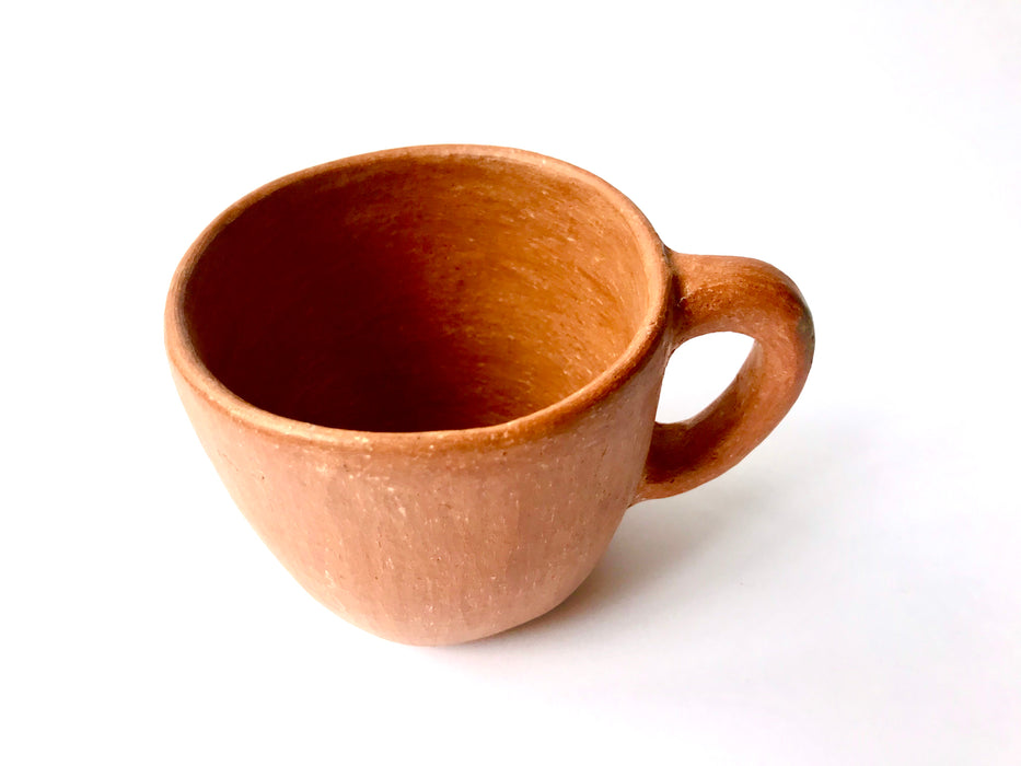 Mexico 1492: A rustic cup, made from red clay with a yellowish tone and marked with random flame spots, adding character. Best for serving coffee, tea, or hot chocolate. Lead free, unglazed. Thanks to the artisanal nature of this handmade product, no two pieces are the same. 