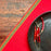 Mexico 1492 - bright red table cloth with colorful edges, handmade on a backstrap loom in Chiapas Mexico. Paired with Black Clay plate from the same shop